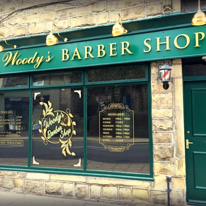 The green and gold Woody's shopfront and its window lettering